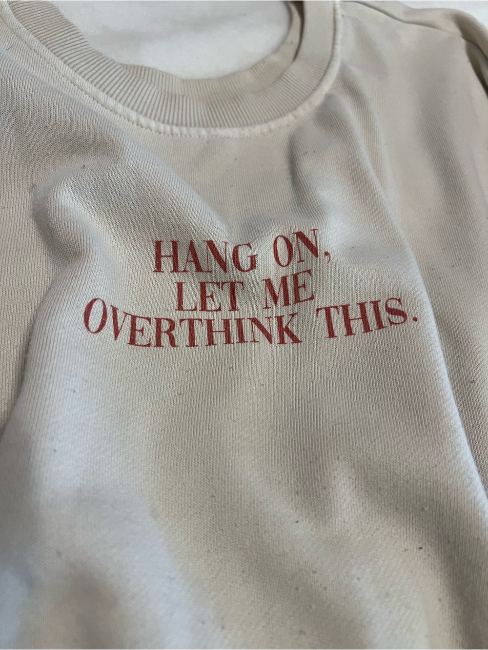 Cream Crewneck Sweater with Red Text Graphic